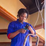 electrician working on wiring in a home